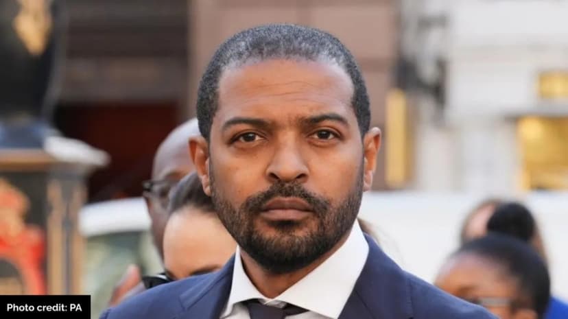 File photograph of Noel Clarke wearing a navy suit, white shirt and dark tie.